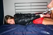 Alina tied and gagged in red nylon shorts and a shiny black jacket