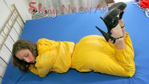 Stella putting on a sexy yellow rainwear combination with high heels waiting for you while lolling on bed (Pics)
