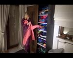 Pia wearing a purple rainwear tidying up the rainwear cupboard (Video)