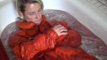 Sexy Sonja taking a bath in the bath tub wearing a sexy shiny nylon down jacket and a rain pants (Video)