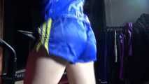 Watching sexy Sandra wearing a sexy blue/yellow shiny nylon shorts and a blue rain jacket during her workout (Video)