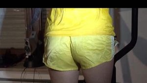 Lucy wearing a supersexy yellow shiny nylon shorts and a yellow rain jacket during her workout on the hometrainer (Video)