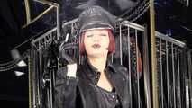 Mistress Tokyo smoking cigarette in leather, gloves and Muir Cap; fetish, POV