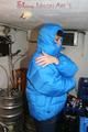 Jill posing in a cooling room wearing a shiny nylon rainpants and a down jacket (Pics)