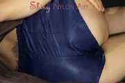 Sexy SANDRA wearing only a very hot blue shiny nylon shorts playing with a bed cloth and posing on a sofa (Pics)