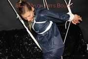 Sexy Sandra being tied and gagged overhead with ropes and a ballgag wearing a sexy blue rain pants and a rain jacket (Pics)