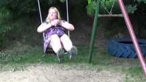 Miri cuffed on a swing