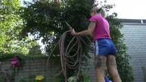 Watch Maly in her shiny nylon Shorts enjoying the warm Weather in the Garden