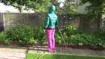 Watching Sandra taking a sun bath and watering the garden the pest plants wearing a sexy purple rain pants and a green down jacket (Video)