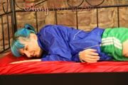 Mara posing on a princess bed in an old cellar wearing a green shiny nylon shorts and a blue rain jacket (Pics)