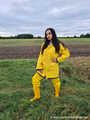 Miss Amira on the road in a Frisian mink, yellow rain dungarees and rubber boots