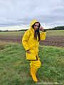 Miss Amira on the road in a Frisian mink, yellow rain dungarees and rubber boots