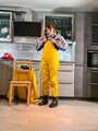 Miss Lara in nylon rain suit and yellow rain dungarees is bound and gagged