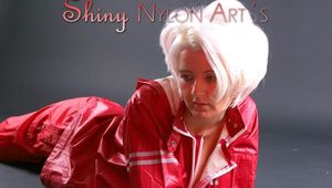 Blonde archive girl posing in a studio wearing a sexy red AGU rainwear combination (Pics)