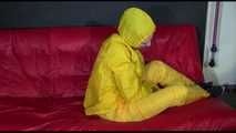 ***MARA*** ties and gagges with cuffs on the sofa wearing a supersexy oldschool yellow rain suit with hood (Video)