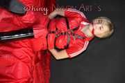 ***HOT***HOT***HOT***Mia wearing a sexy red shiny nylon jumpsuit and black shiny heel rubber boots being tied and gagged with belts and a clothgag (Pics)