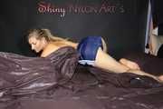 Sexy SANDRA wearing only a very hot blue shiny nylon shorts playing with a bed cloth and posing on a sofa (Pics)