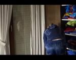 Pia tidying up the cupboard wearing darkblue shiny nylon shorts and a blue rain jacket (Video)