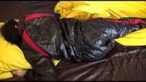 Lucy wearing a sexy black/red shiny nylon downsuit preparing her bed with nylon linen and enjoys it (Video)