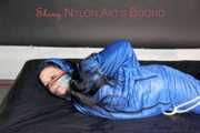 Lucy wearing sexy lightblue downwear tied and gagged with ropes and cloth gag on a bed (Pics)