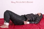 Pia tied, gagged and hooded in bed wearing a shiny black rain pants a a shiny black downjacket (Pics)