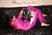 Watching sexy Mara lying on a black shiny sofa wearing a sexy pink downsuit reading a book (Pics)