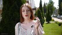 18 y.o. Sasha is smoking two white 120mm cigarettes outdoors