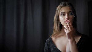 Gorgeous babe Irina posing on camera while smoking a cigarette
