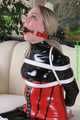 Watch Sophie beeing bound and gagged corsetted in a shiny black PVC catsuit