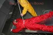 Watching Stella being tied and gagged with ropes and a ballgag on a operating table from Leonie both wearing sexy shiny nylon rainwear (Pics)