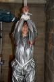 Nicole in an silver shiny PVC sauna suit tied and gagged in an cellar (Pics)