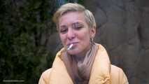 Short cut hair blonde girl is smoking all white 120mm cigarettes