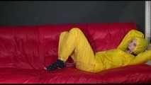 ***MARA*** ties and gagges with cuffs on the sofa wearing a supersexy oldschool yellow rain suit with hood (Video)