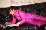 Watching sexy Mara lying on a black shiny sofa wearing a sexy pink downsuit reading a book (Pics)