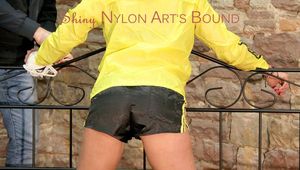 Pia tied and gagged on a princess bed wearing a sexy shiny black shorts and a yellow rain jacket (Pics)