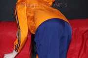 Sexy Lucy wearing a blue shiny nylon rain pants and an orange rain jacket sorting shiny nylon shorts (Pics)