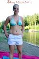 Jenny sunbathing on a lake and go swimming wearing sexy shiny nylon shorts and a bikini-top (Pics)