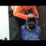 Jill in a shiny blue rainsuit tied,hooded and gagged by Simone under the shower (Video)