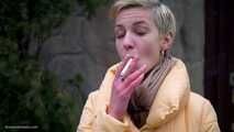 Short cut hair blonde girl is smoking all white 120mm cigarettes
