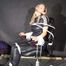 Sexy Sandra being tied and gagged on a hairdresser`s chair with ropes and a ballgag wearing a sexy black shiny nylon jumpsuit (Video)