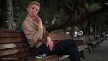 Short cut hair blonde girl is smoking all white 120mm cigarettes