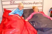 Jenny and Yvonne putting clean sheets on the bed wearing shiny nylon shorts and rain jacket (Pics)