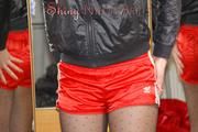 Watching Pia dressing herself with a red shiny nylon shorts over her nylons and a rain jacket (Pics)