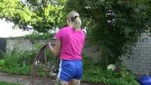 Watch Maly in her shiny nylon Shorts enjoying the warm Weather in the Garden