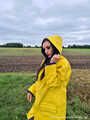 Miss Amira on the road in a Frisian mink, yellow rain dungarees and rubber boots