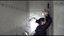 Jill tied and gagged taking a shower wearing sexy shiny nylon shorts and a rain jacket (Video)