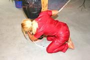 Jill tied and gagged by an blond archive girl on a pillar both wearing shiny nylon rainwear (Pics)