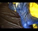 Lucy playing with zipper and lolling on a bed wearing supersexy blue AGU rainwear (Video)