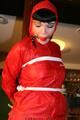 Jill bound in a red nylon rainsuit
