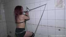 Bella chained to the cool wall